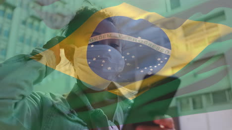 brazil waving flag against asian woman wearing face mask using smartphone on the street