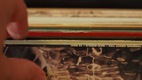 close up man hands browsing vintage vinyl records at home