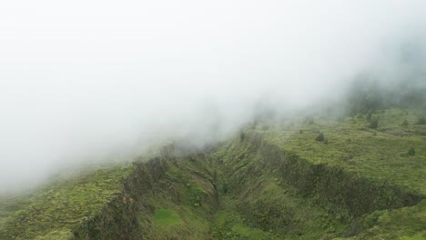 lush green landscape of lagoa do fogo, shrouded in mist, creating a mysterious atmosphere