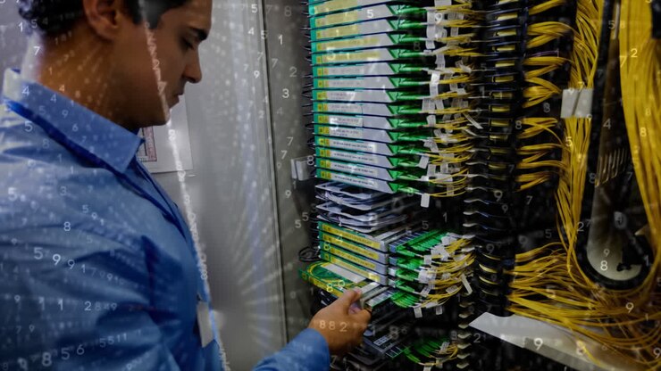 Managing network cables, technician working in server room with data processing animation