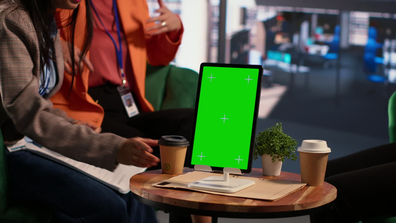 Businesswomen in a Meeting with a Green Screen Tablet