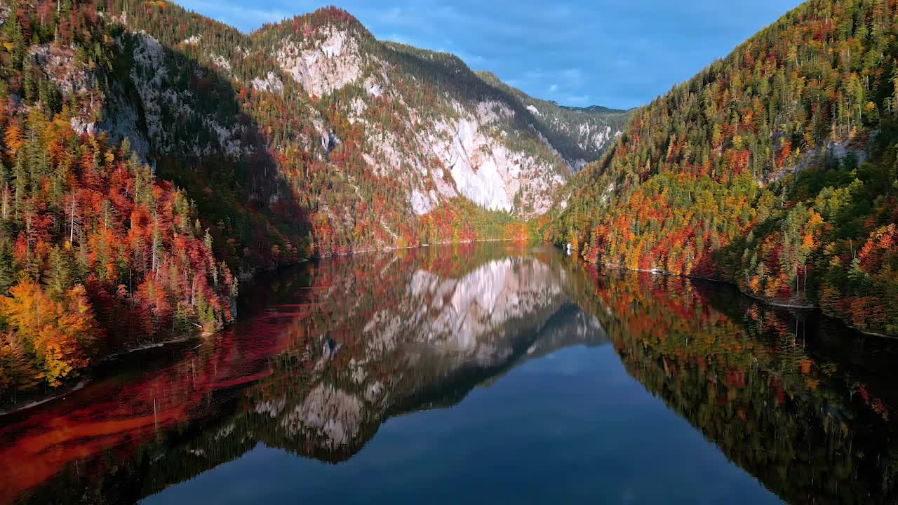 Bird's eye view of the colorful mountain forests reflecting in Lake Toplitz, Austria
