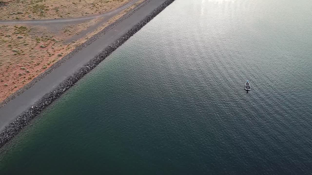 Drone Aerial View of Coastal Road and Boat in Water Reservoir Lake of Sand Hollow State Park, Uta USA
