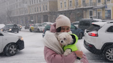 woman with dog in snowy city street