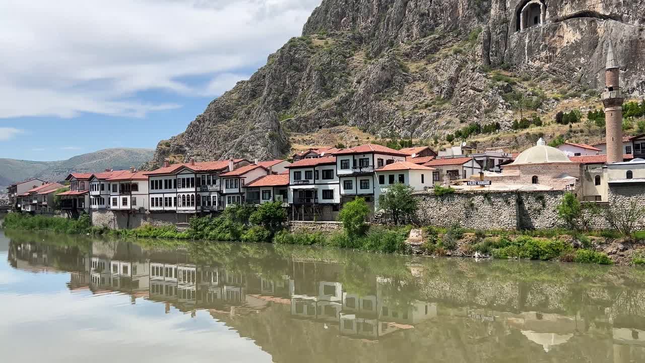 Waterside houses and Pontic Greek cemeteries carved into the mountains on the banks of the Yesilırmak River in Amasya, Turkey