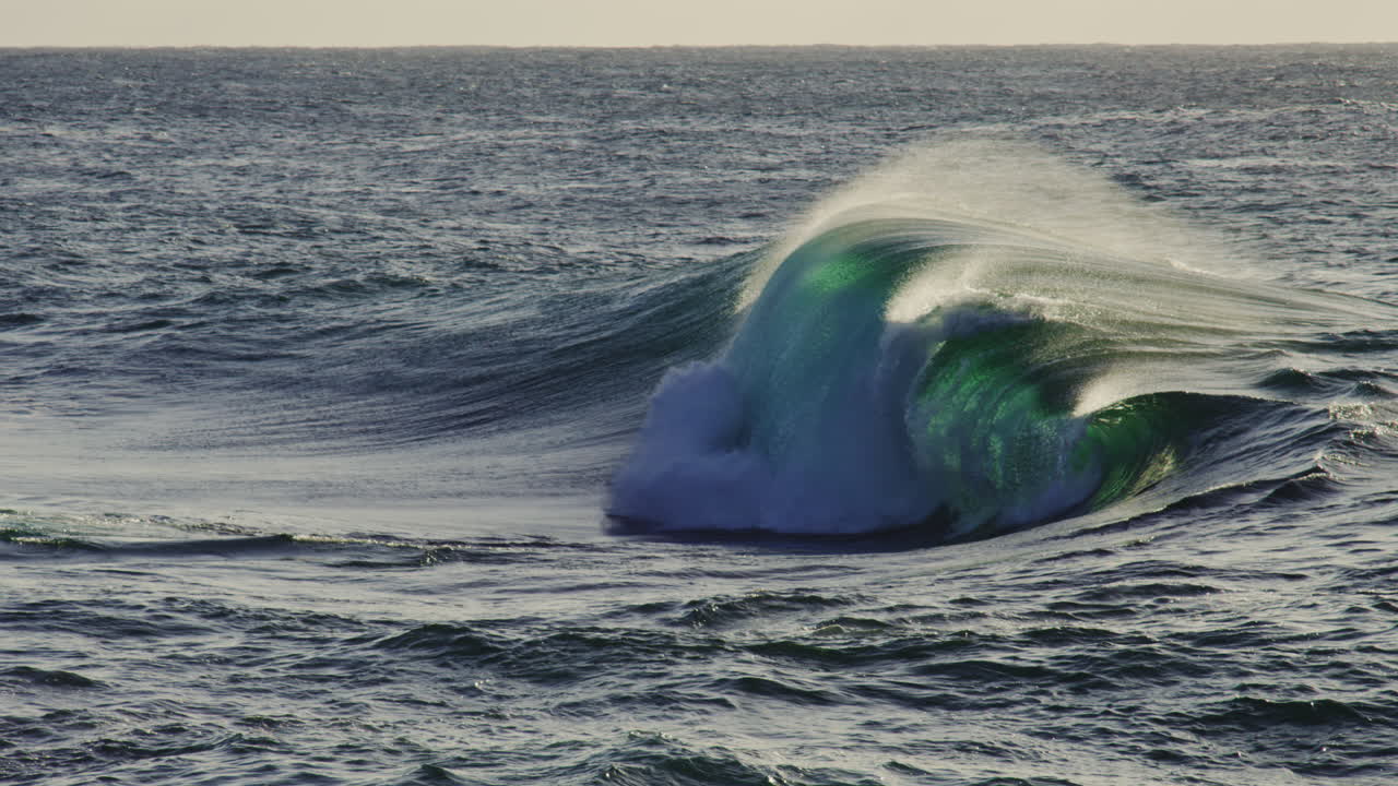 Slow ocean surface movement with long gentle waves under soft daylight, tranquil seascape, backdrop empty with perfect clear green waves
