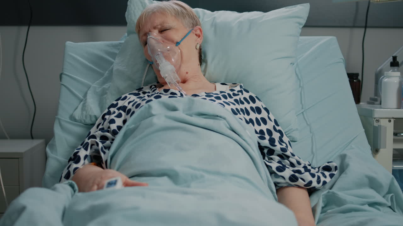 Retired woman with oxygen tube against respiratory problem