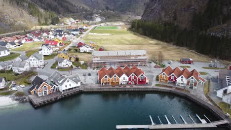 modalen town center with a marina close to houses and a public beach - norways richest municipality aerial