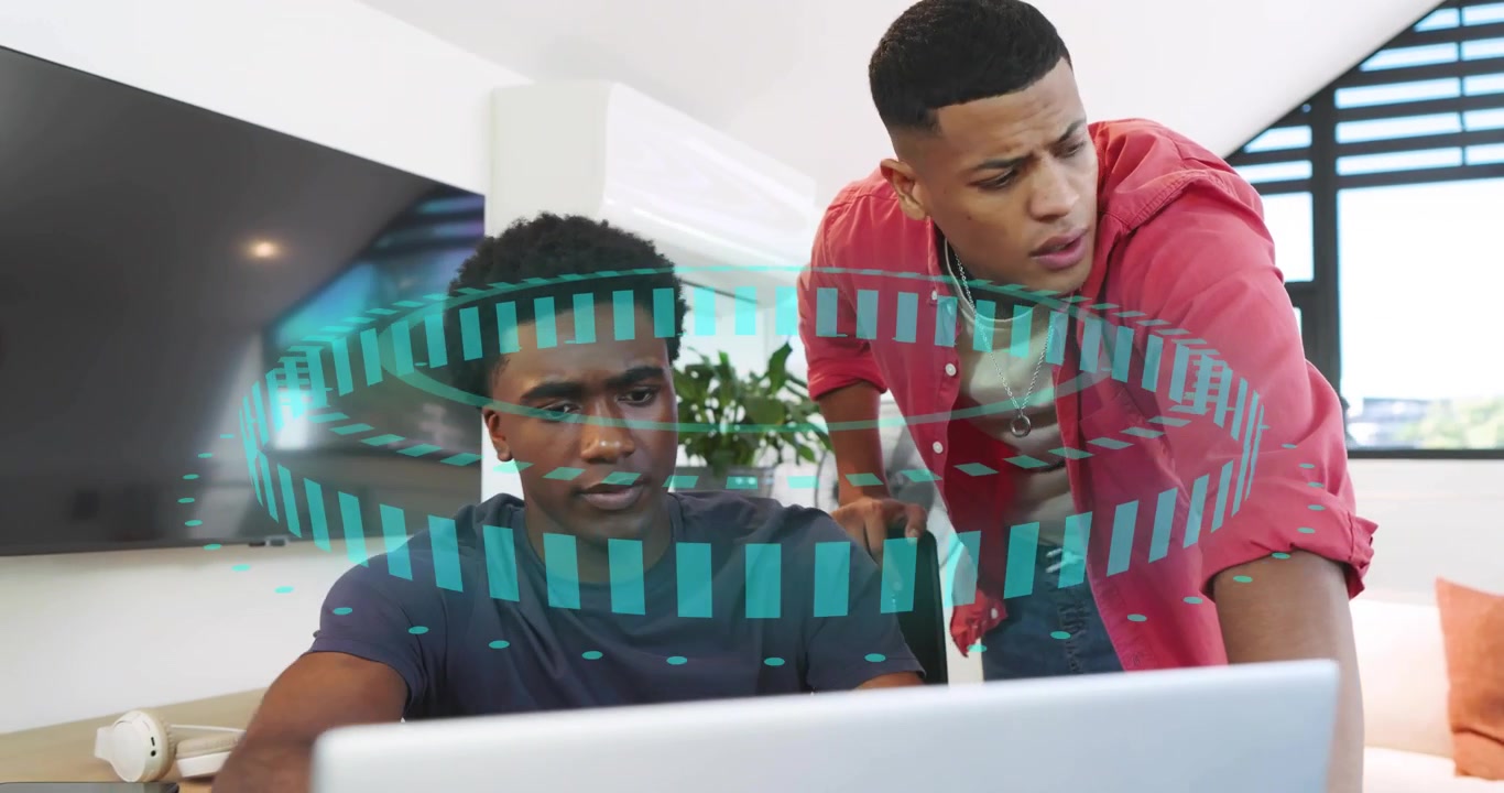 Colleagues initiating data update by typing and pointing at holographic data overlay over laptop