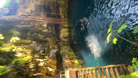 cliff jumping into a cenote in mexico