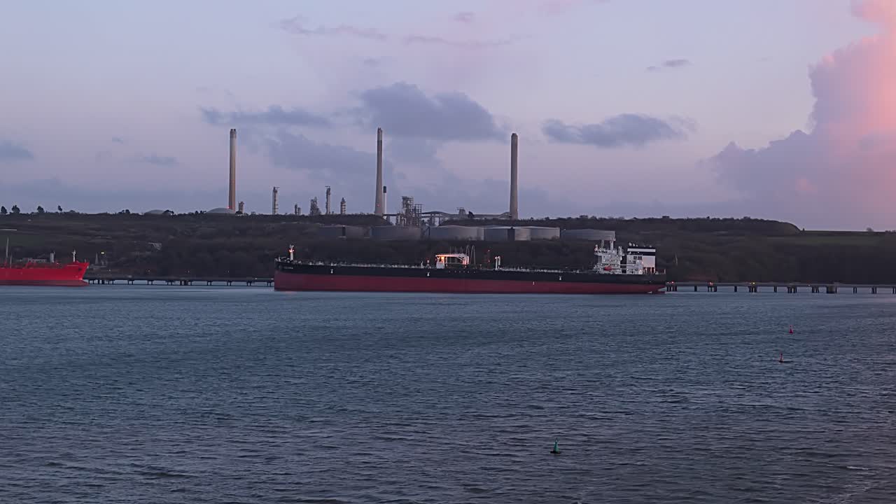 Large oil tanker docked at Valero Pembroke Refinery in the UK, industrial view