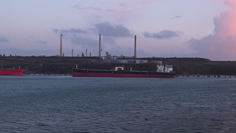 large oil tanker docked at valero pembroke refinery in the uk, industrial view