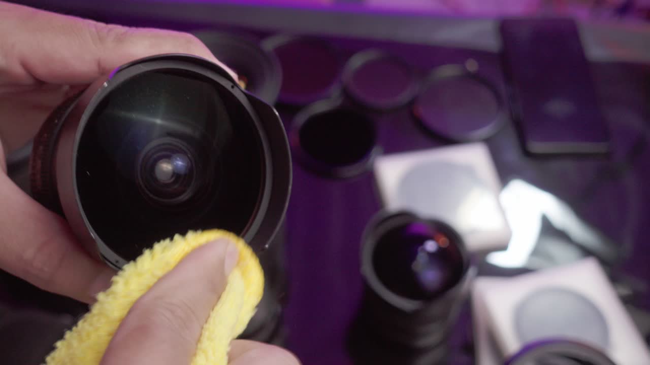 Close-up video of the cleaning professional camera lenses