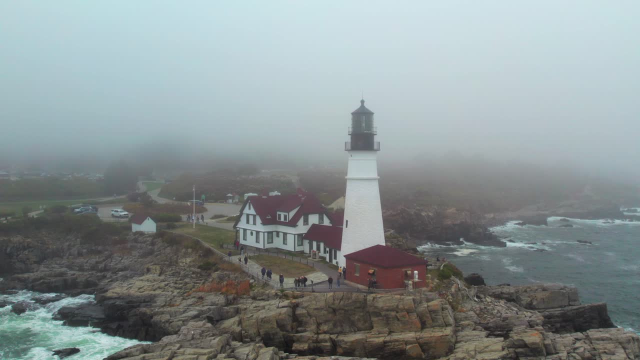Lighthouse in deep fog, rugged winter coastal shot, 4K