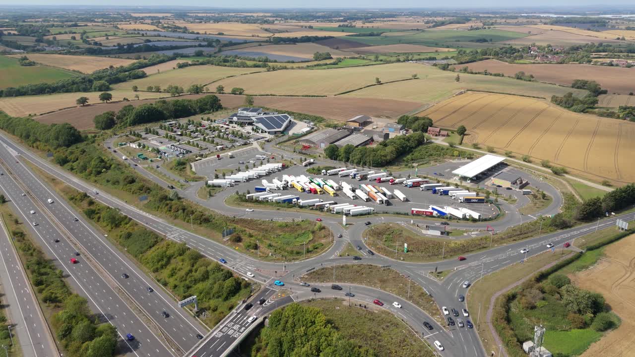 Top down aerial drone shot of motorway junction and large distribution centres in Rugby England UK