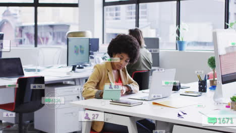 animation of icons and numbers over african american businesswoman in office