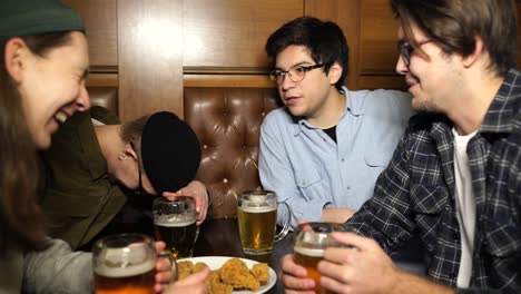 friends enjoying beer and food at a pub