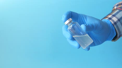 medical professional holding a vial of medicine