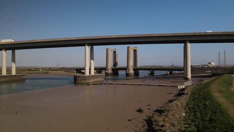 vehicles driving through kingsferry bridge in the isle of sheppey in kent, england - panning shot