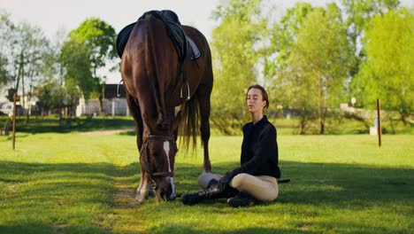 woman interacting with horse in a field