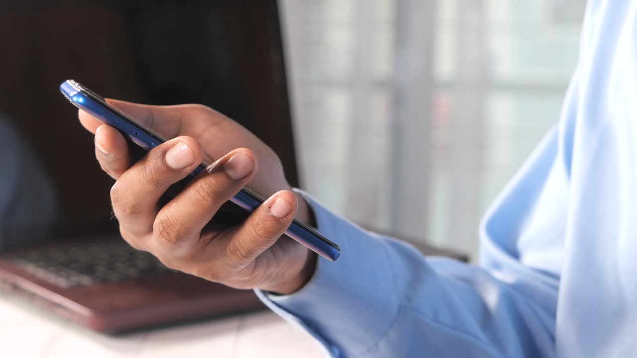 Man Using Smartphone in Office