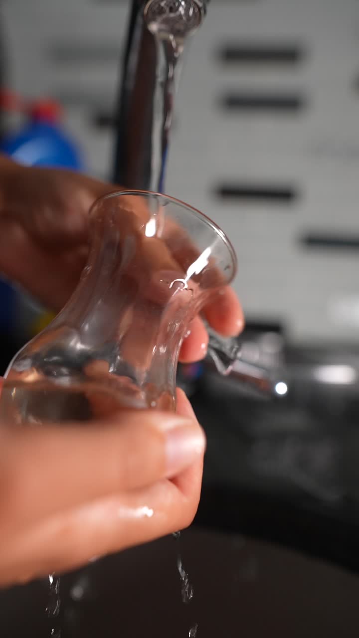 lavar un vaso con agua corriente