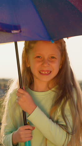 girl stands rotating umbrella under rain. child under raindrops danced upon fabric creating mesmerizing symphony of nature rhythm. spreading joy