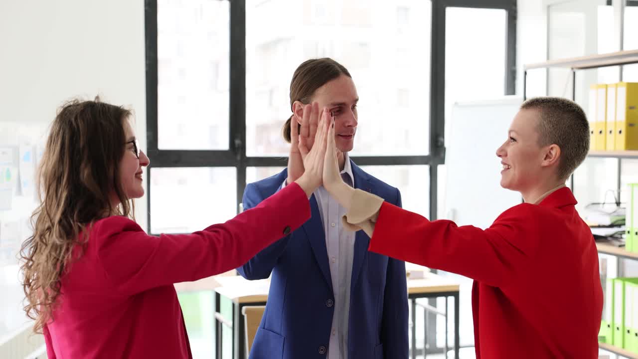 Business team celebrating success with high five