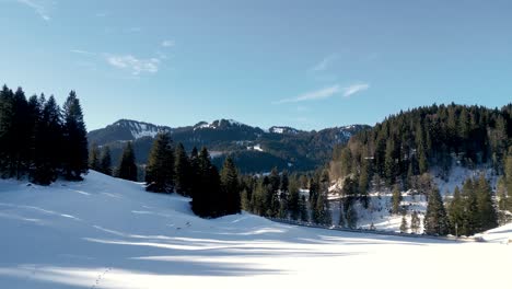 Captivating-Aerial-Drone-View-of-Winter-Mountains-in-Bavarian-Alps,-Germany:-Snow-Blanketed-Landscape-near-Spitzingsee-Lake,-Alpine-Majesty-from-Above