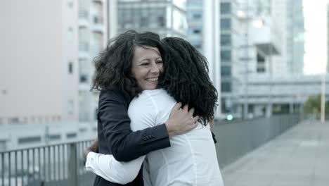 Slow-motion-shot-of-happy-female-friends-meeting-and-talking