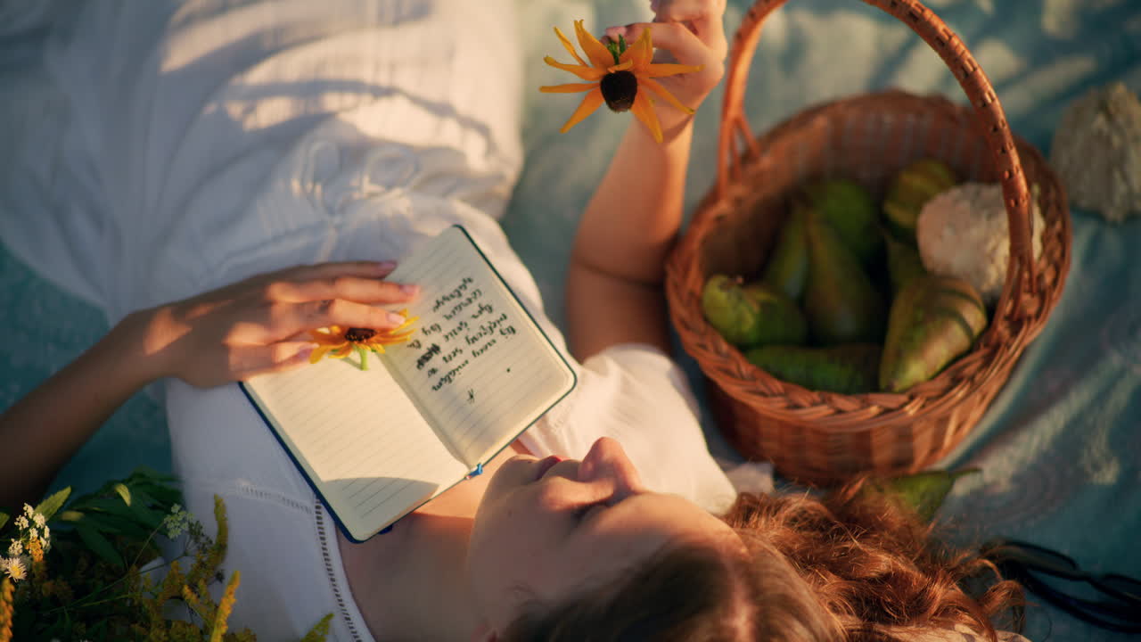 Child resting on grass lost in summer dreams