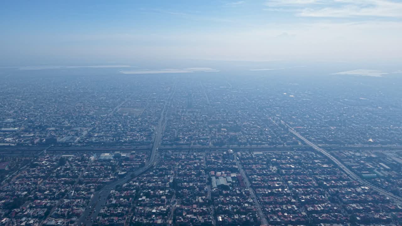 Drone view from above showing Ecatepec’s dense urban area under smog