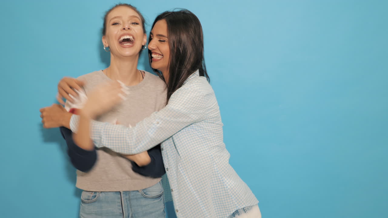 두 명의 행복한 여성들이 포옹하고 있습니다.