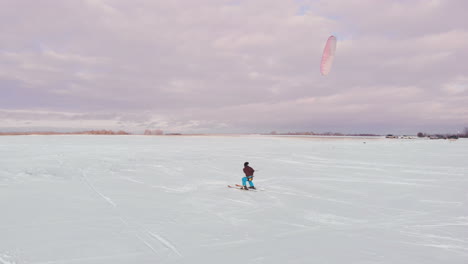 man ski on snow kite holds an action camera and takes a picture of selfie.