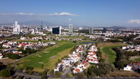 Aerial-establishing-shot-showing-golf-Course-and-suburb-neighborhood-at-sunny-day