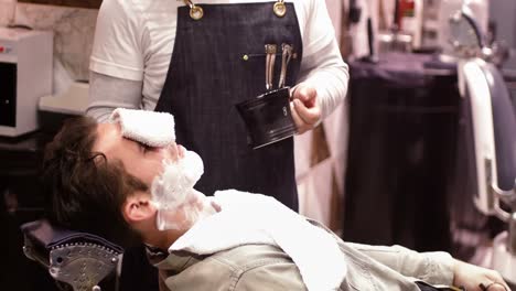 Man-getting-his-beard-shaved-with-shaving-brush