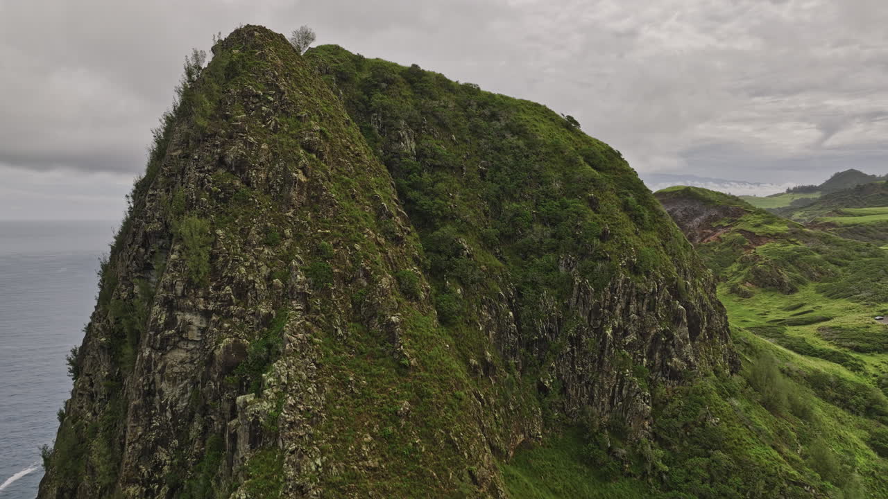 Maui Hawaii Aerial v20 flyover and around the heights of Pu'u Koa'e capturing mountain valley covered in lush vegetations, tilt down reveals Kahakuloa Bay view - Shot with Mavic 3 Cine - December 2022