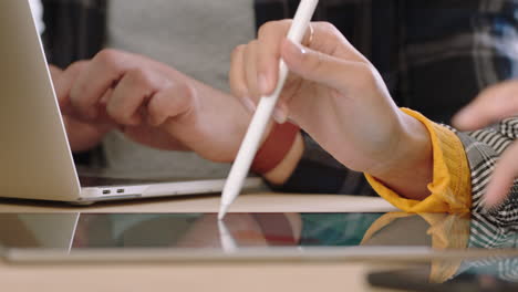 close up hands business woman using digital tablet computer showing businessman information poitnting stylus pen at screen on mobile touchscreen device