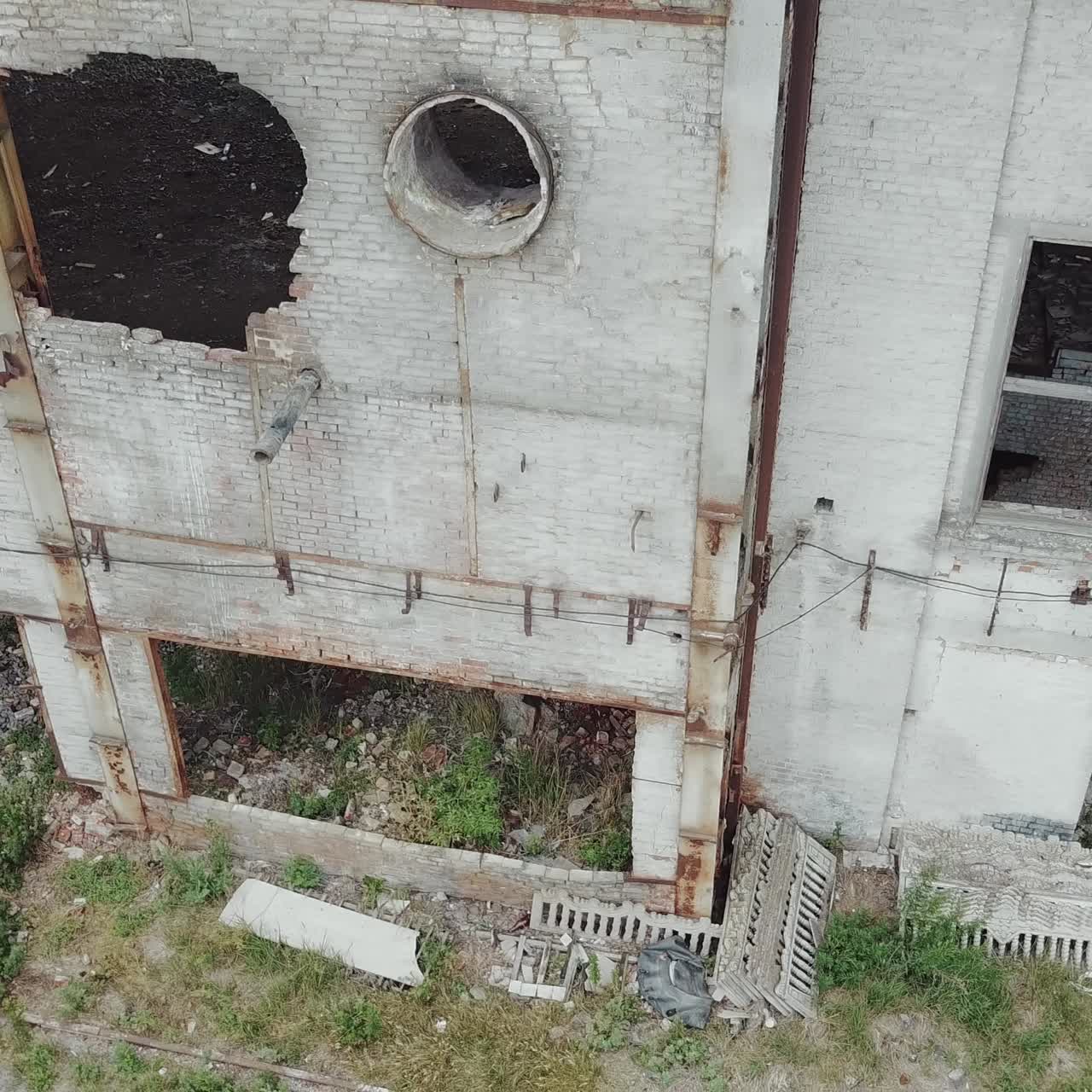 Aerial view of a destroyed factory during the war. Abandoned industrial building.