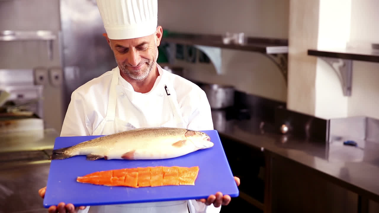 Chef showing fillet of salmon