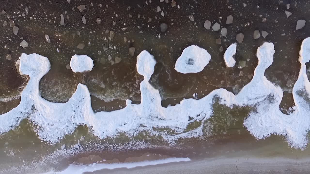 Seaside icy waves in winter morning light