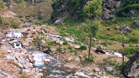 group of people in rocky stream in srinagar