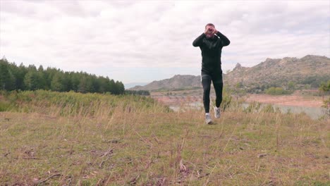 Man-training-on-the-grass-of-a-meadow-near-a-forest