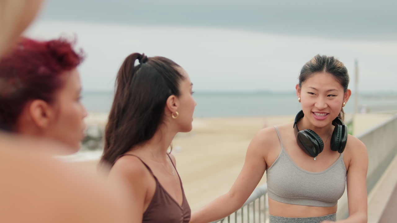 Female Friends Chat After Beach Workout