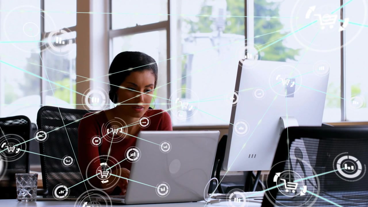 Woman typing, initiating animated graphs expanding over laptop for business while coworker passing