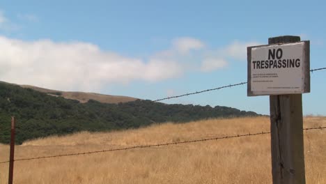 Time-lapse-of-clouds-drifting-past-a-no-trespassing-sign-3