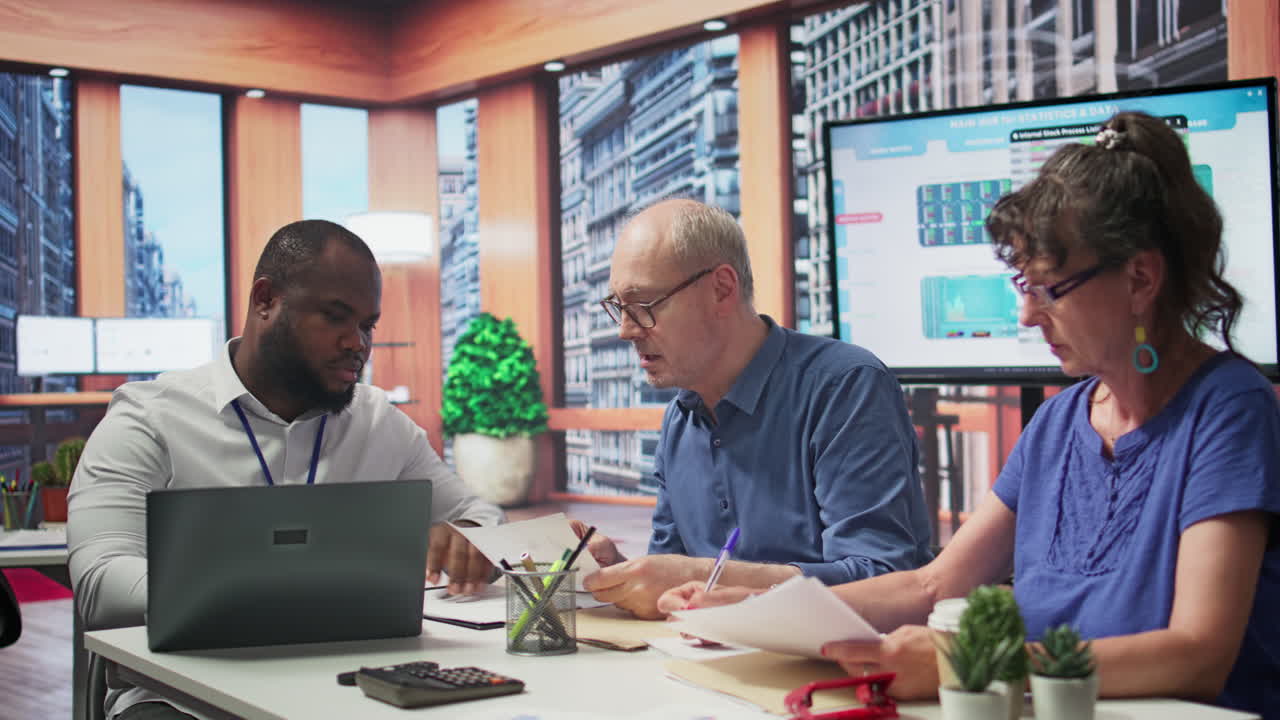 Elderly pair meeting with financial expert to examine various pension options