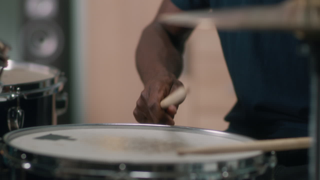 African American Guy Playing Drums in Studio Close up Shot of Black Guy Playing Drums with Drumsticks during in Music Studio