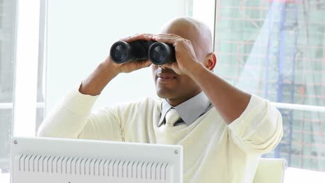 afroamerican businessman looking through binoculars