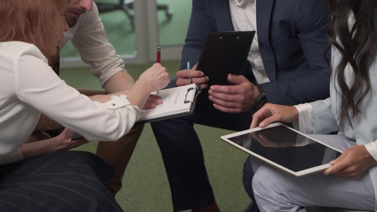 A Working Group Of Two Businesswomen And Two Businessmen In The Middle Of A Brainstorming Session 7